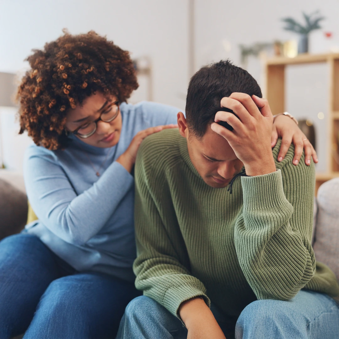 Supportive woman comforting a man in crisis, representing care through Arizona Complete Health coverage.