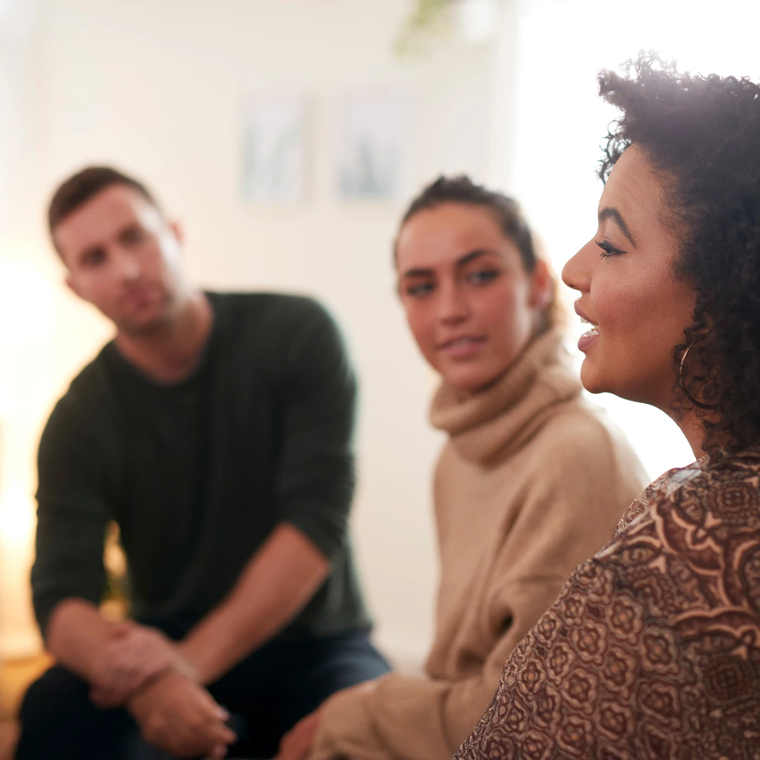 The-Future-is-Bright-at-Changes-Healing-Center Adults in a small group conversation; one woman speaks while others listen—reflecting a welcoming, judgment-free admissions process at Changes Healing Center.