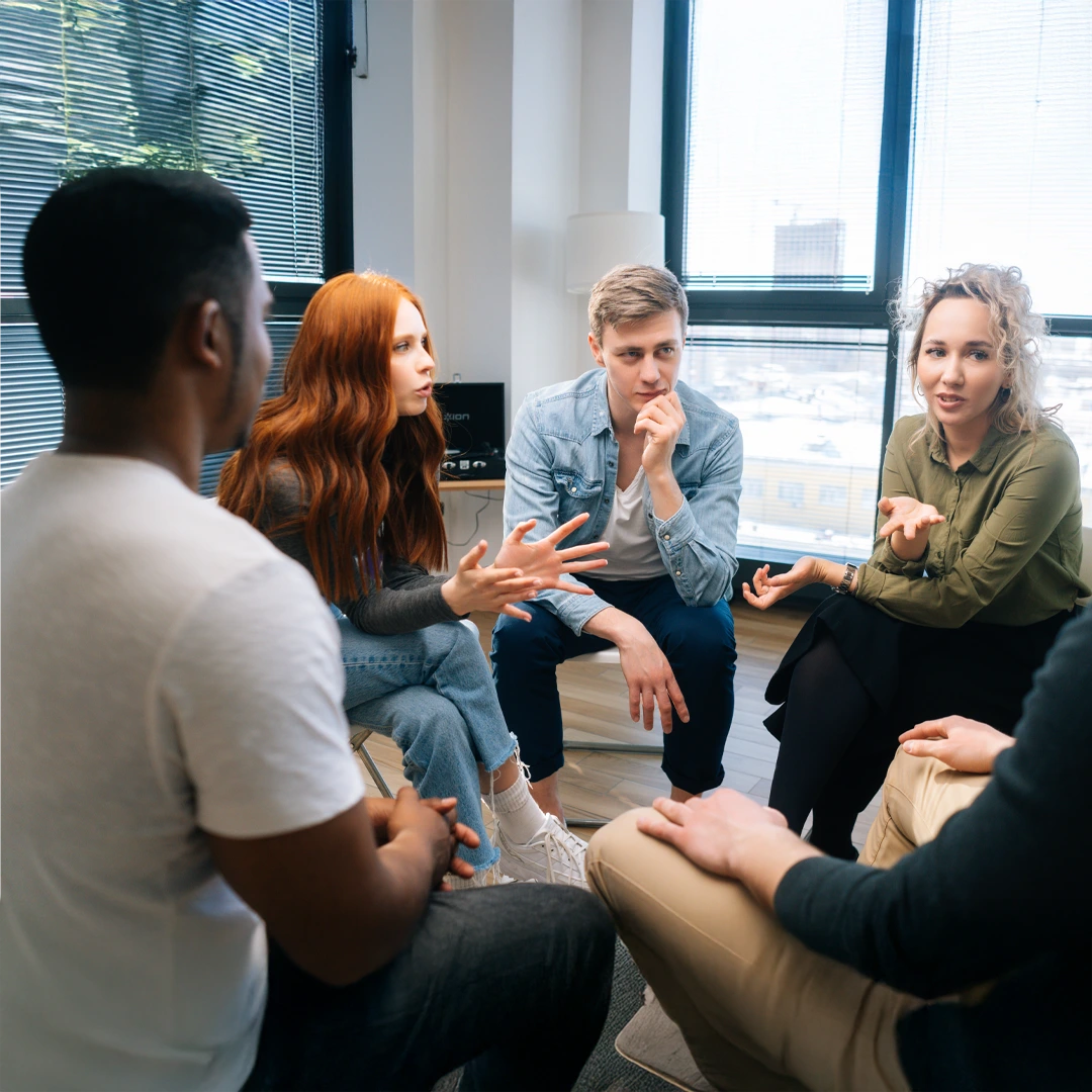 ambetter-coverage-mental-health-and-addiction-treatment-arizona-group-discussion Smiling woman in group therapy at Changes Healing Center—Ambetter insurance accepted in Arizona.