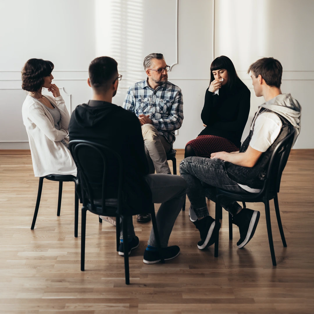 Therapy group seated in a circle with a clinician, illustrating how Changes Healing Center’s PHP in Arizona treats the root causes of addiction.