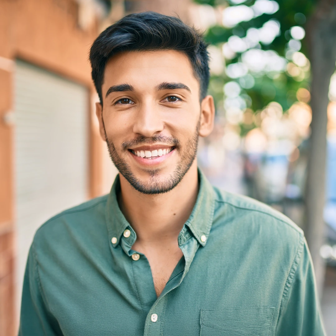 Smiling young adult outdoors, reflecting whole-person residential treatment in Phoenix–Scottsdale, Arizona.